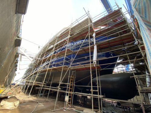 Photo of ISSG's new freight vessel under construction in Vietnam - Menawethan - photo shows scaffolding around vessel and freshly painted hull